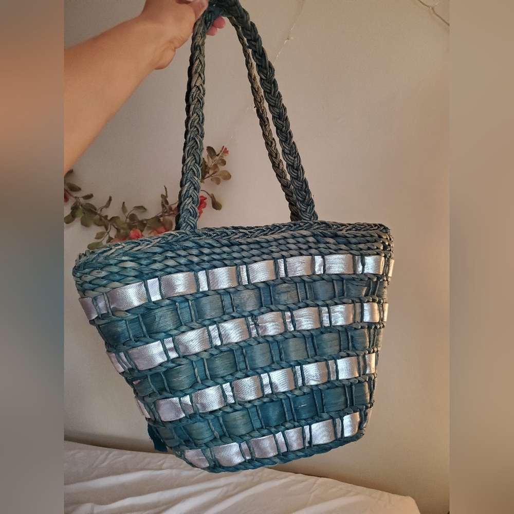 Blue straw bag with silver accents. Woven purse